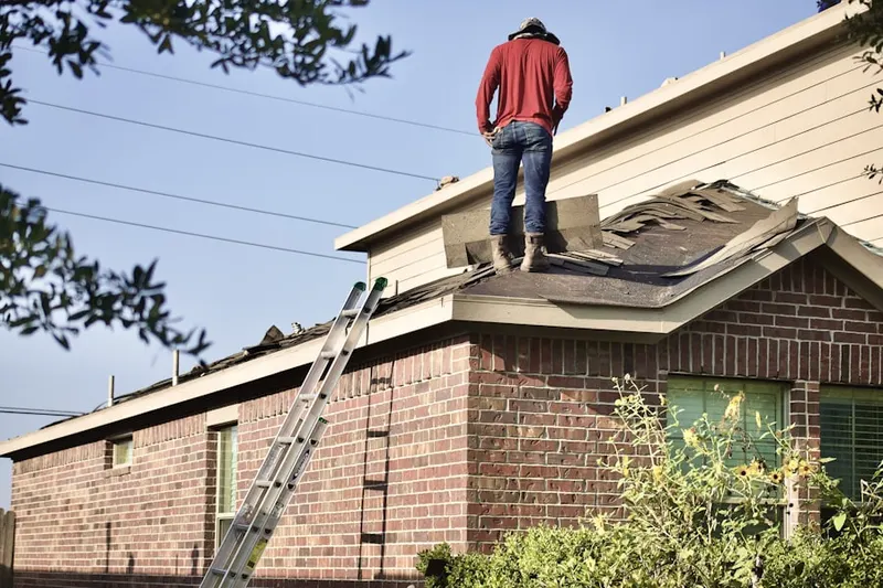 Professional roofer working on a residential roof in East Central